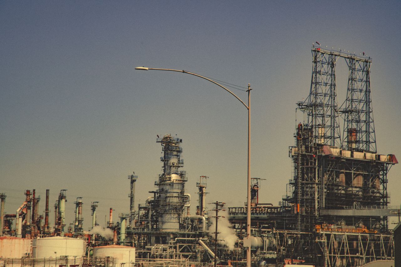 Towers, pipework and storage tanks at a refinery, where plastic resins are produced.